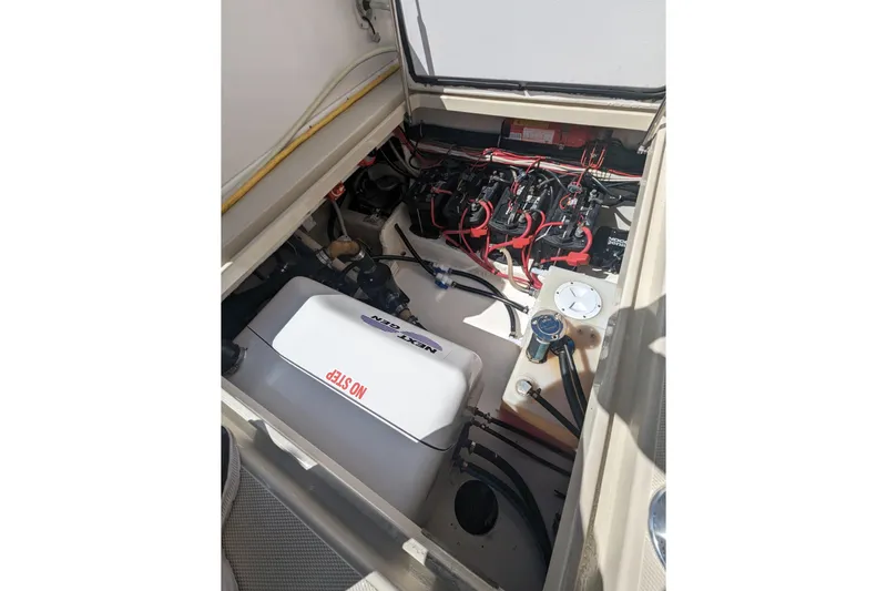 'why Knot' Yacht Photos Pics Engine compartment of 2008 Donzi 38 ZSF boat, showcasing wiring and components.