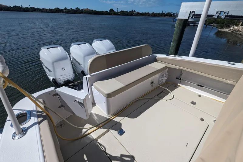 'why Knot' Yacht Photos Pics 2008 Donzi 38 ZSF boat with triple outboard engines docked by the water.