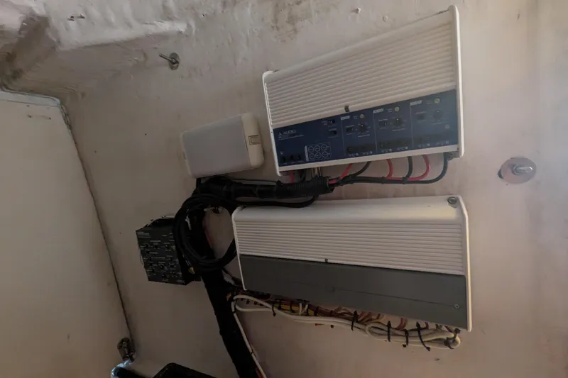 'why Knot' Yacht Photos Pics Electrical components inside a 2008 Donzi 38 ZSF boat, featuring wiring and control panels.