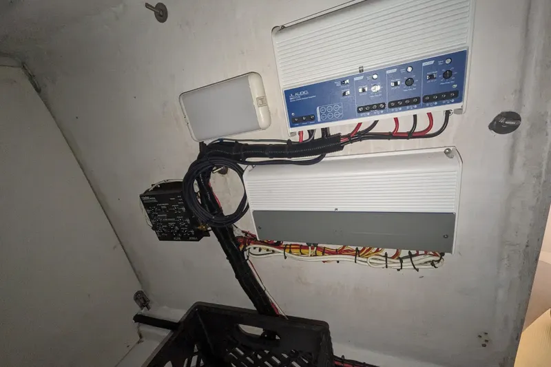 'why Knot' Yacht Photos Pics Electrical system inside a 2008 Donzi 38 ZSF boat, featuring wiring and control panels.