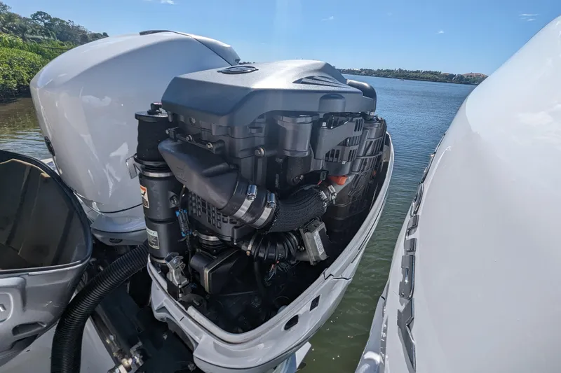 'why Knot' Yacht Photos Pics 2008 Donzi 38 ZSF boat engine, open cover, near water, clear sky background.