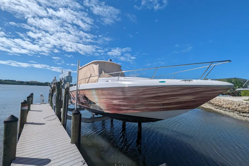 'why Knot' Yacht Photos Pics 2008 Donzi 38 ZSF boat docked on a sunny day with blue sky.