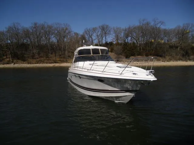  Yacht Photos Pics 2017 Formula 40 Performance Cruiser on calm water near a wooded shoreline.
