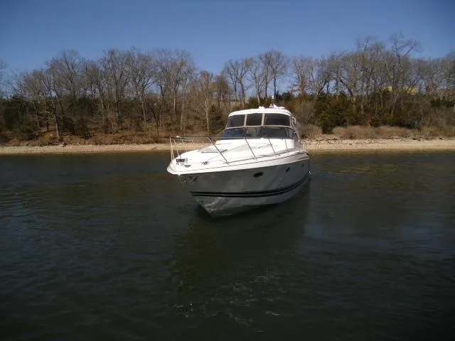  Yacht Photos Pics 2017 Formula 40 Performance Cruiser on calm water near a wooded shoreline.