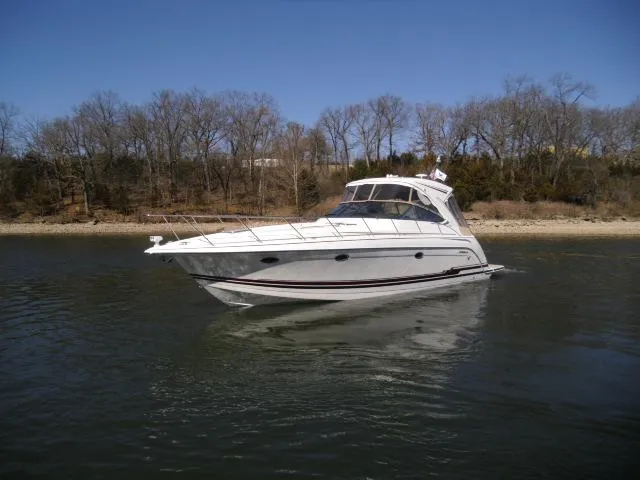  Yacht Photos Pics 2017 Formula 40 Performance Cruiser on calm water near a wooded shoreline.