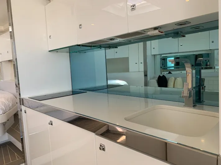 Geminis Yacht Photos Pics Modern kitchen interior of 2014 VanDutch 55 yacht with sleek white cabinetry.