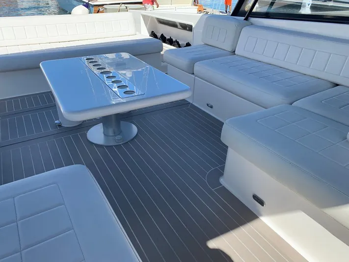 Geminis Yacht Photos Pics Luxurious seating area on a 2014 VanDutch 55 yacht with white upholstery and a sleek table.