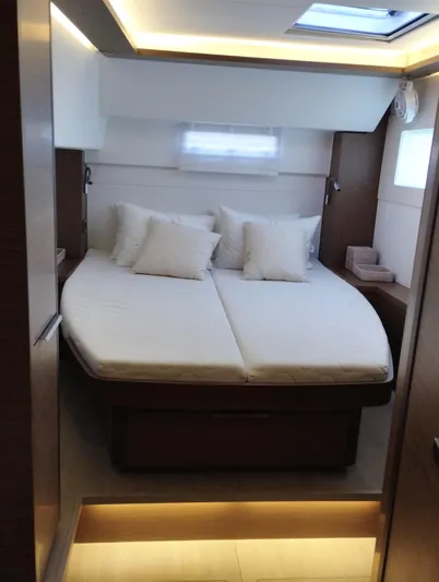 Alma De Sur Yacht Photos Pics Luxurious cabin interior of 2021 Lagoon 46 yacht with cozy bedding.