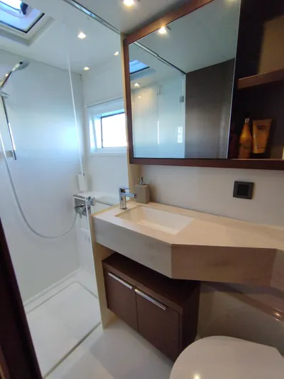 Alma De Sur Yacht Photos Pics Modern bathroom interior in 2021 Lagoon 46 yacht, featuring sleek fixtures and ample lighting.