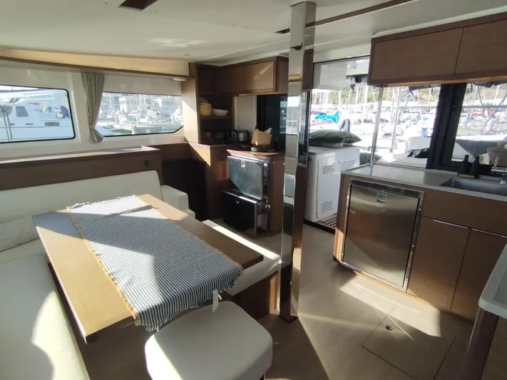 Alma De Sur Yacht Photos Pics Interior of 2021 Lagoon 46 catamaran with modern kitchen and dining area.