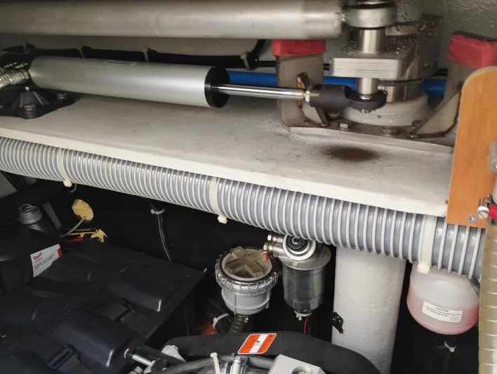 Alma De Sur Yacht Photos Pics Engine compartment of a 2021 Lagoon 46 catamaran, showcasing mechanical components and hoses.