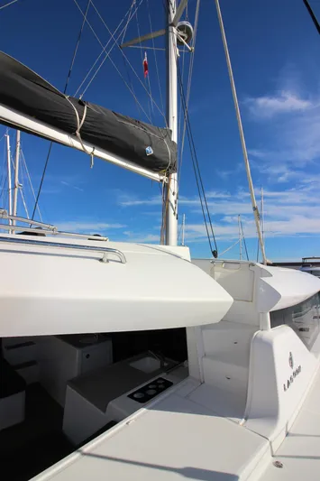 Alma De Sur Yacht Photos Pics 2021 Lagoon 46 catamaran with sleek design and spacious deck under clear blue sky.