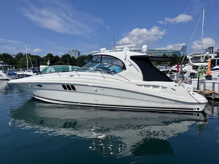  Yacht Photos Pics 2007 Sea Ray 44 Sundancer yacht docked in a marina under a clear blue sky.