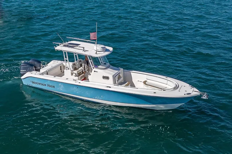  Yacht Photos Pics 2015 Edgewater 320CC boat cruising on open water with American flag.