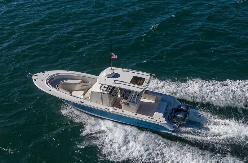  Yacht Photos Pics 2015 Edgewater 320CC boat cruising on open water, aerial view.