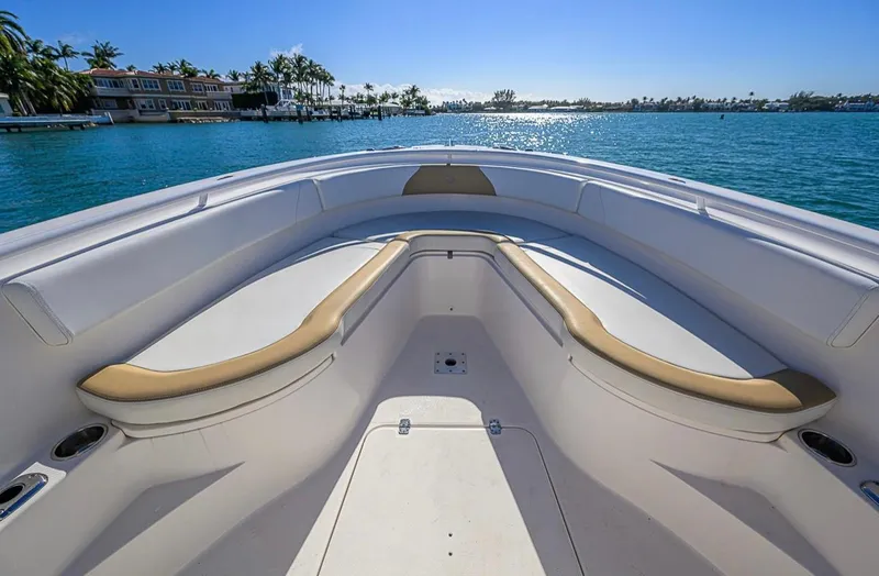  Yacht Photos Pics 2015 Edgewater 320CC boat interior with cushioned seating, overlooking serene blue waters.