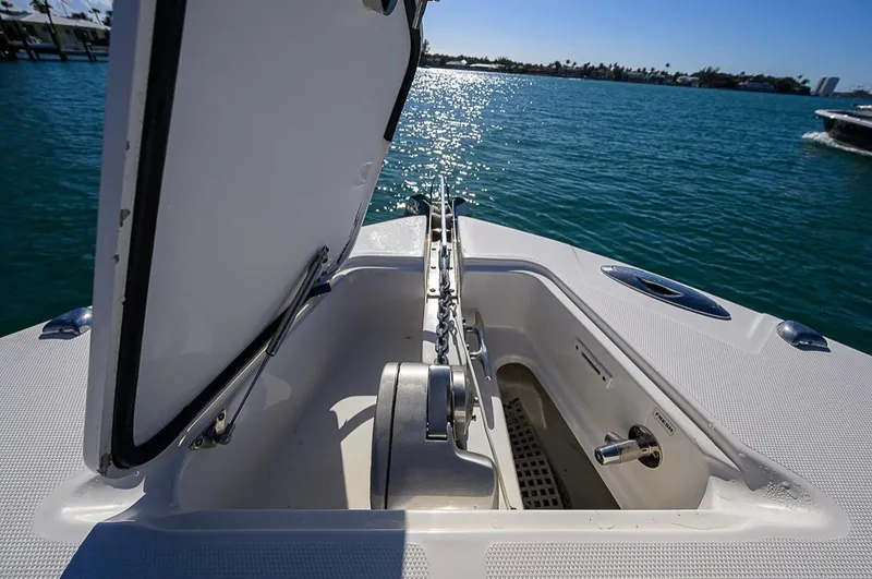  Yacht Photos Pics Open anchor compartment on 2015 Edgewater 320CC boat, with ocean view in background.