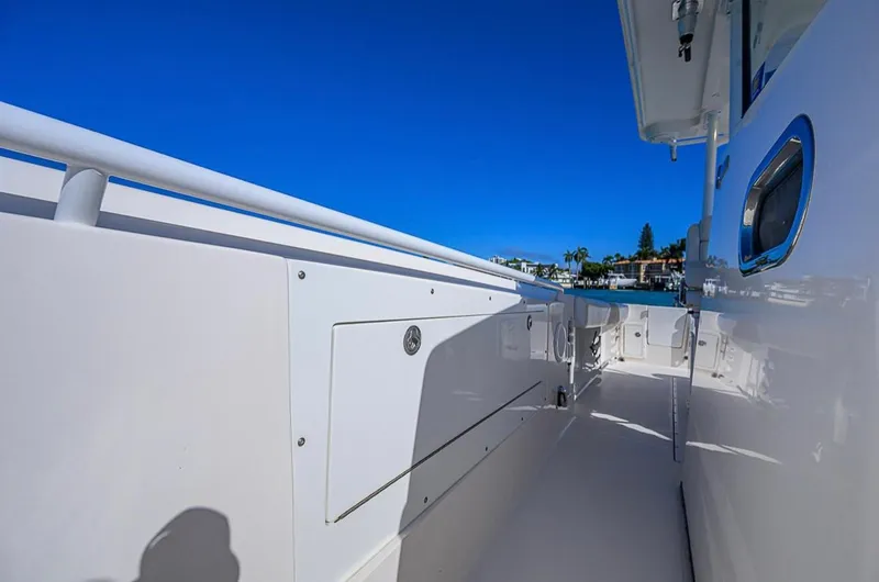  Yacht Photos Pics 2015 Edgewater 320CC boat deck with clear blue sky and waterfront view.