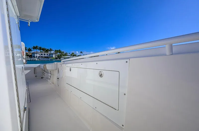  Yacht Photos Pics Edgewater 320CC 2015 boat deck with storage, clear blue sky, and waterfront view.