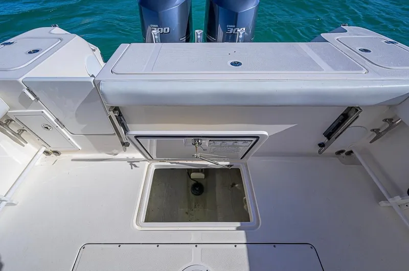  Yacht Photos Pics 2015 Edgewater 320CC boat deck with storage compartment and twin Yamaha engines.