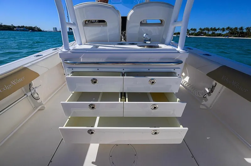  Yacht Photos Pics 2015 Edgewater 320CC boat with open storage drawers on deck, ocean background.