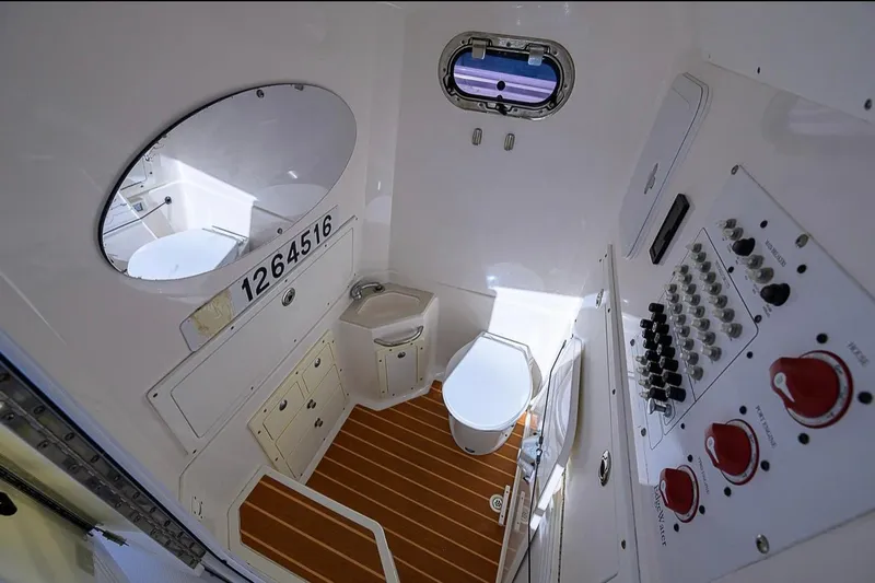  Yacht Photos Pics Interior of 2015 Edgewater 320CC boat featuring a compact bathroom with control panel.