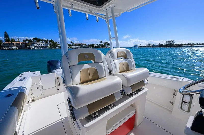  Yacht Photos Pics 2015 Edgewater 320CC boat interior with dual seats, on a sunny day by the water.