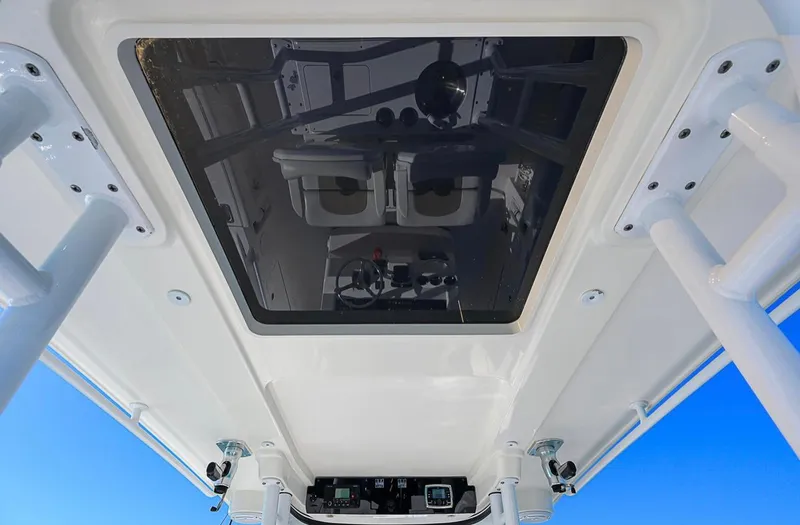  Yacht Photos Pics 2015 Edgewater 320CC boat roof with glass panel and blue sky background.