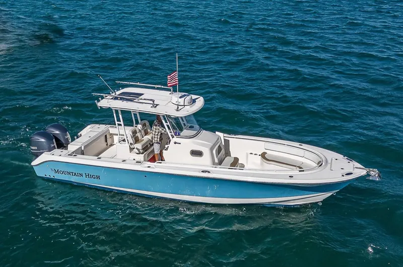  Yacht Photos Pics 2015 Edgewater 320CC boat named "Mountain High" cruising on open water.