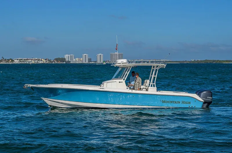  Yacht Photos Pics 2015 Edgewater 320CC boat "Mountain High" cruising on blue ocean waters.