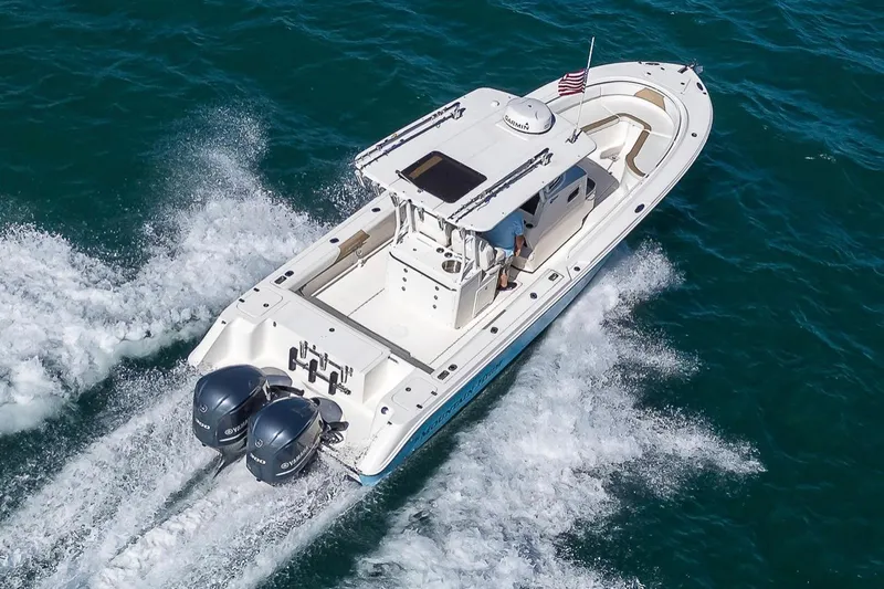  Yacht Photos Pics 2015 Edgewater 320CC boat cruising on open water with twin engines.