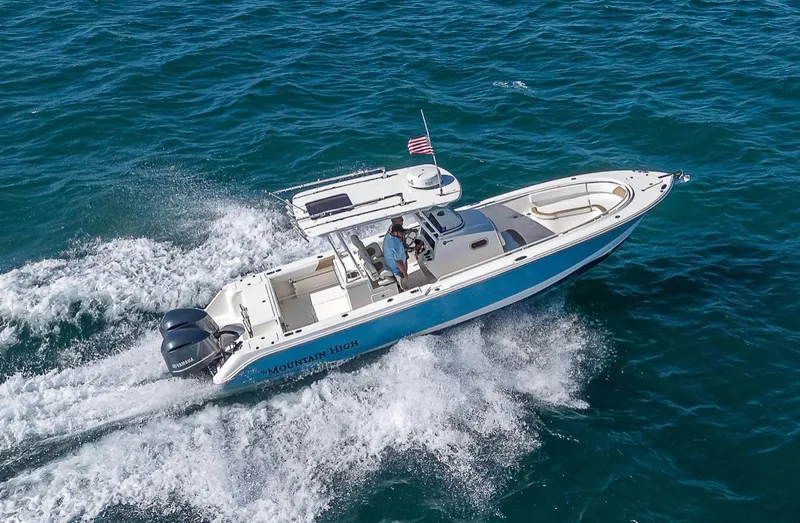  Yacht Photos Pics Edgewater 320CC 2015 boat cruising on open water with American flag.