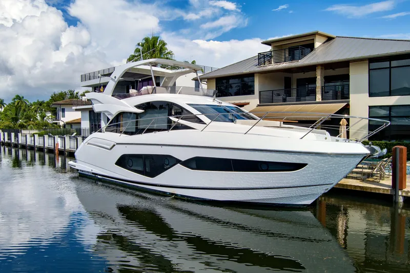 Joie De Vivre Yacht Photos Pics Luxury Sunseeker Manhattan 52 yacht docked by modern waterfront home, 2020 model.