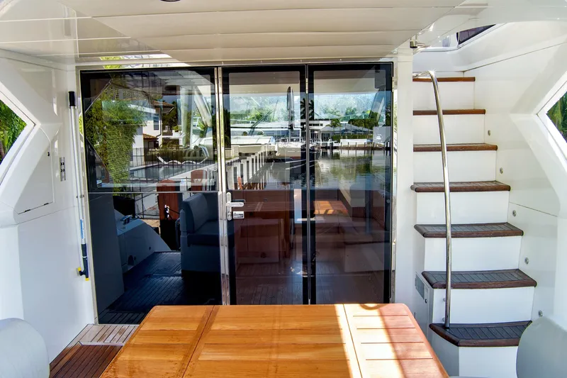 Joie De Vivre Yacht Photos Pics Sunseeker Manhattan 52 yacht interior with wooden table and stairs, 2020 model.
