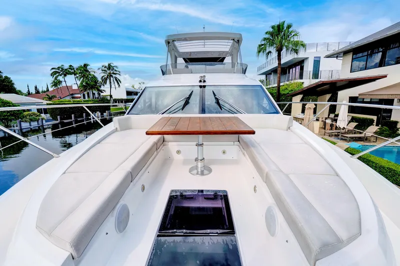 Joie De Vivre Yacht Photos Pics 2020 Sunseeker Manhattan 52 yacht with spacious deck, luxurious seating, and wooden table.