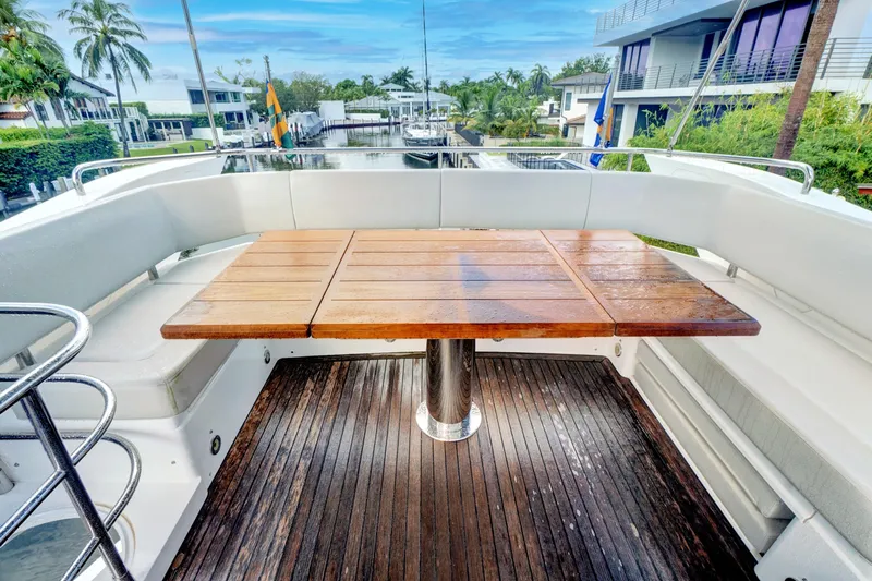 Joie De Vivre Yacht Photos Pics Sunseeker Manhattan 52 yacht deck with wooden table and seating, 2020 model.