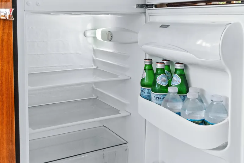 Joie De Vivre Yacht Photos Pics Refrigerator inside 2020 Sunseeker Manhattan 52 yacht, stocked with bottled water and sparkling water.