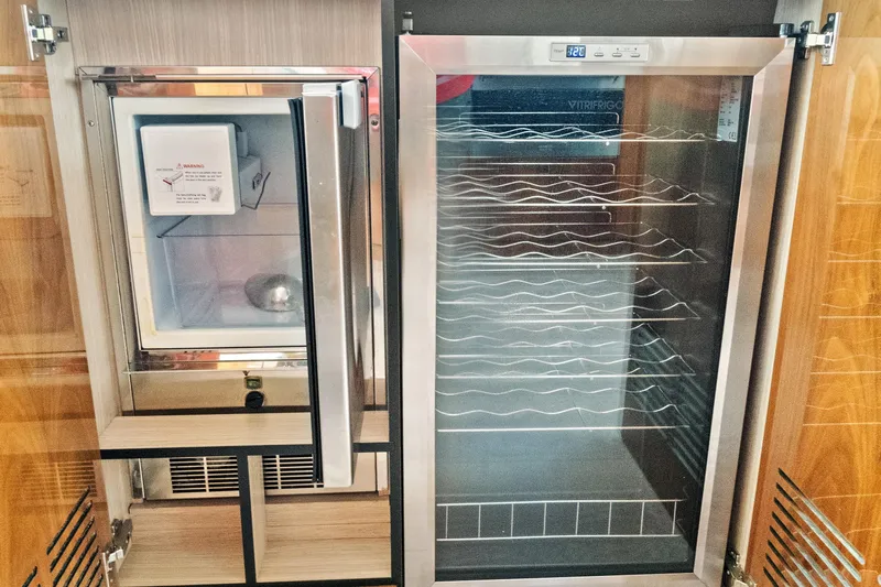 Joie De Vivre Yacht Photos Pics Luxury yacht Sunseeker Manhattan 52, 2020 model, featuring a modern fridge and wine cooler.