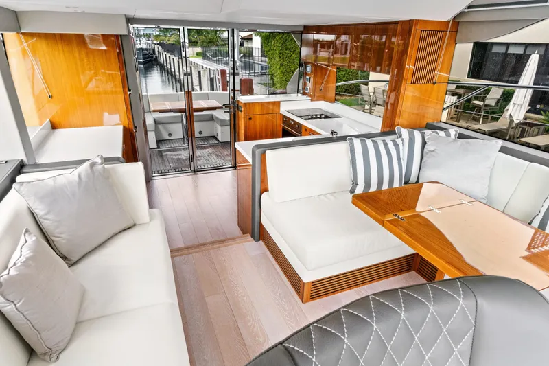 Joie De Vivre Yacht Photos Pics Luxurious interior of 2020 Sunseeker Manhattan 52 yacht with elegant seating and modern kitchen.