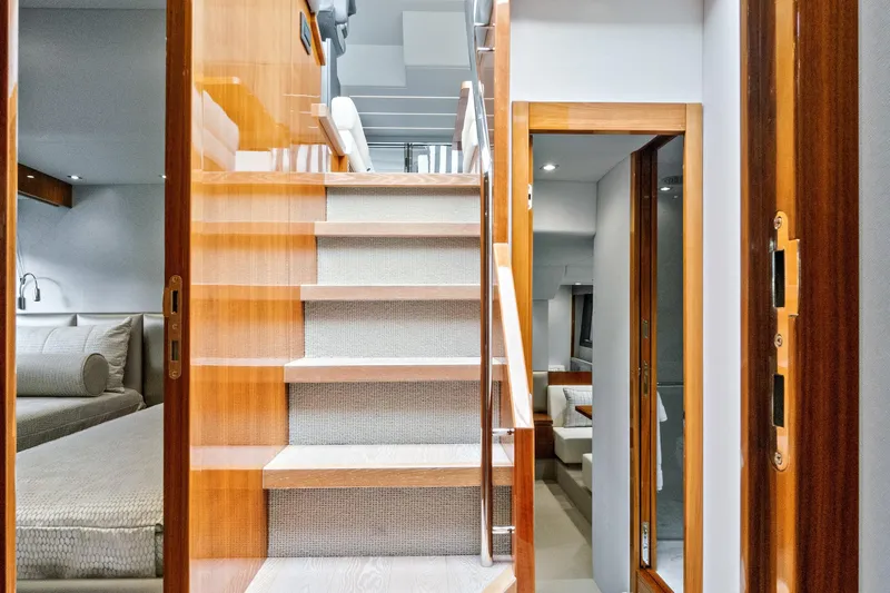 Joie De Vivre Yacht Photos Pics Luxurious interior of 2020 Sunseeker Manhattan 52 yacht with wooden stairs and modern design.