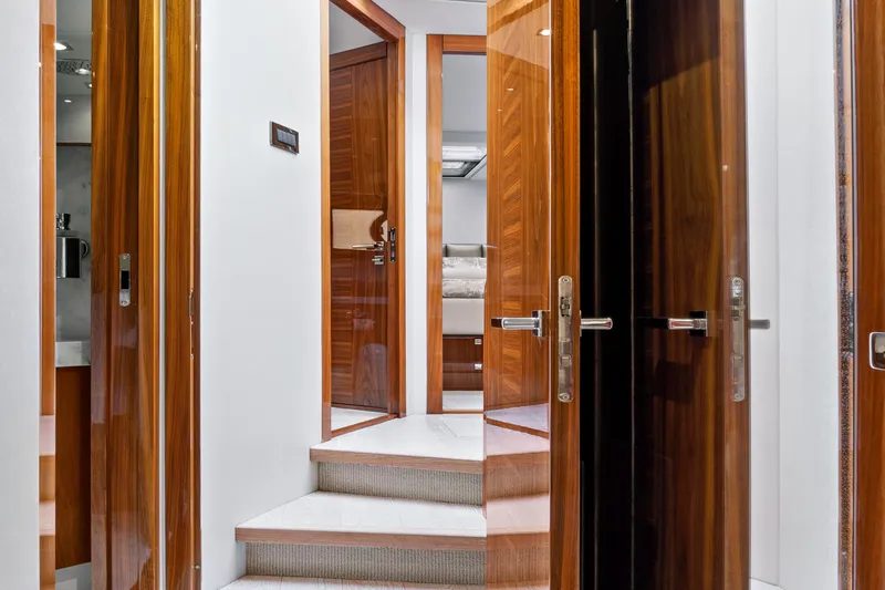 Joie De Vivre Yacht Photos Pics Luxurious interior of 2020 Sunseeker Manhattan 52 yacht with wooden doors and elegant staircase.