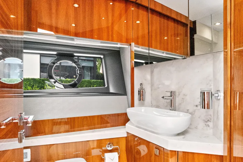 Joie De Vivre Yacht Photos Pics Luxurious bathroom in 2020 Sunseeker Manhattan 52 yacht with modern fixtures and wood accents.