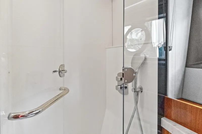 Joie De Vivre Yacht Photos Pics Luxurious shower area in 2020 Sunseeker Manhattan 52 yacht, featuring sleek glass and chrome fixtures.