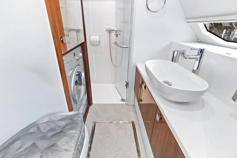 Joie De Vivre Yacht Photos Pics Luxurious bathroom in 2020 Sunseeker Manhattan 52 yacht with modern fixtures and washing machine.