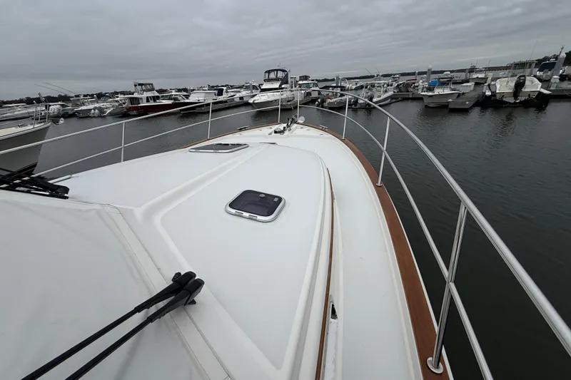 Kay Lee Jean Yacht Photos Pics 2023 Sabre 43 Salon Express yacht docked at marina, overcast sky.