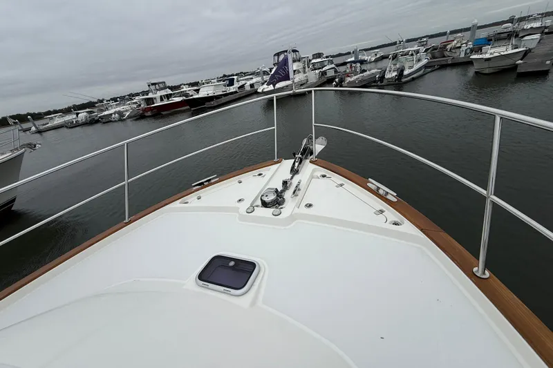 Kay Lee Jean Yacht Photos Pics 2023 Sabre 43 Salon Express yacht bow at marina, showcasing sleek design and railing.