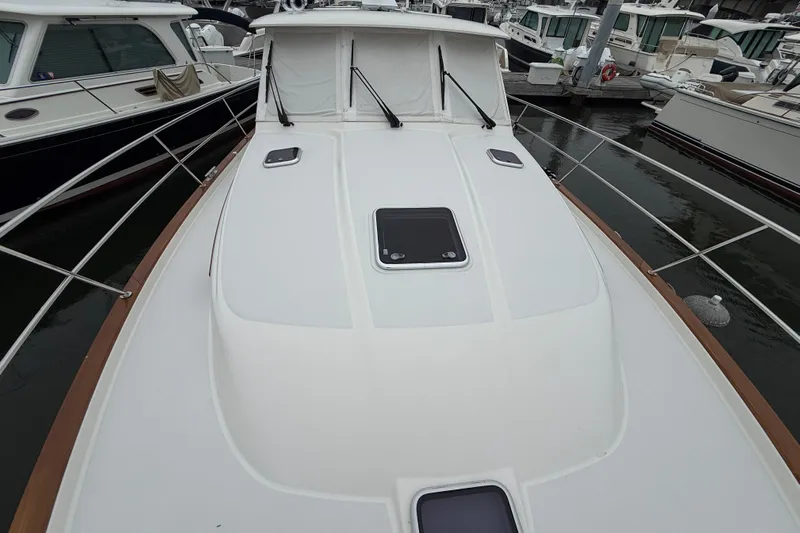 Kay Lee Jean Yacht Photos Pics 2023 Sabre 43 Salon Express yacht docked at marina, showcasing sleek deck design.