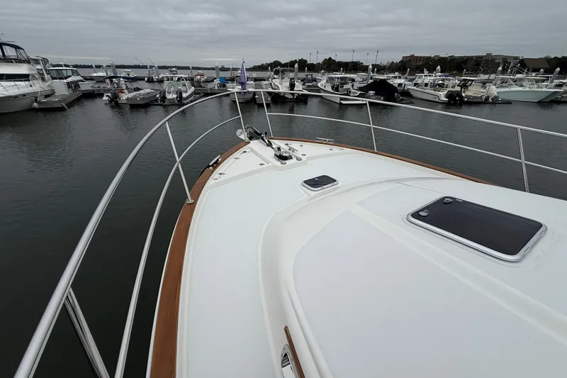 Kay Lee Jean Yacht Photos Pics 2023 Sabre 43 Salon Express yacht docked at marina under cloudy skies.