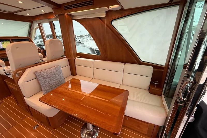 Kay Lee Jean Yacht Photos Pics Luxurious interior of 2023 Sabre 43 Salon Express yacht with elegant seating and wooden table.
