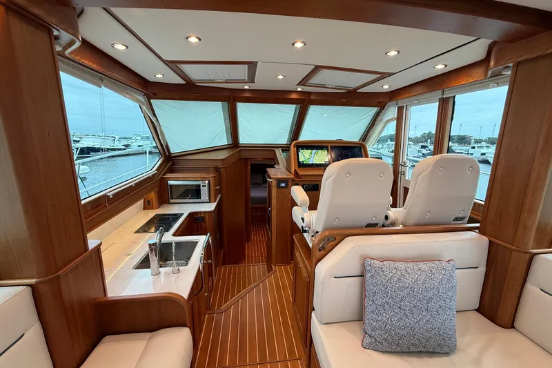 Kay Lee Jean Yacht Photos Pics Interior of 2023 Sabre 43 Salon Express yacht with luxurious seating and navigation area.